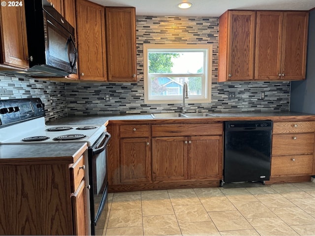 kitchen with black appliances, sink, and tasteful backsplash