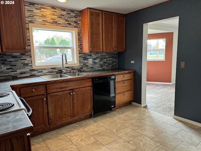 kitchen featuring dishwasher, a textured ceiling, tasteful backsplash, and sink