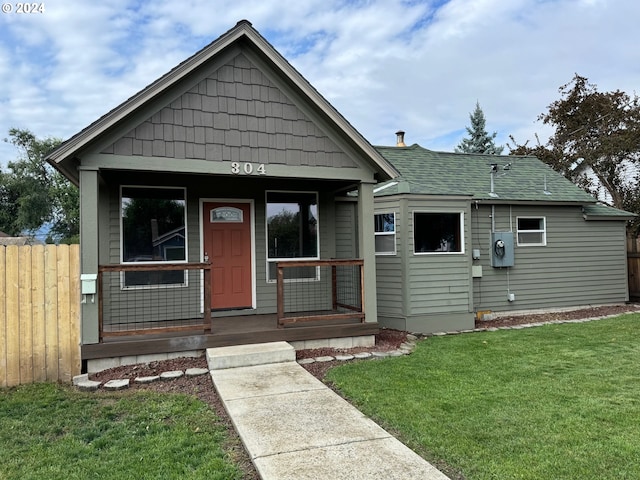 bungalow-style house with a front lawn and covered porch