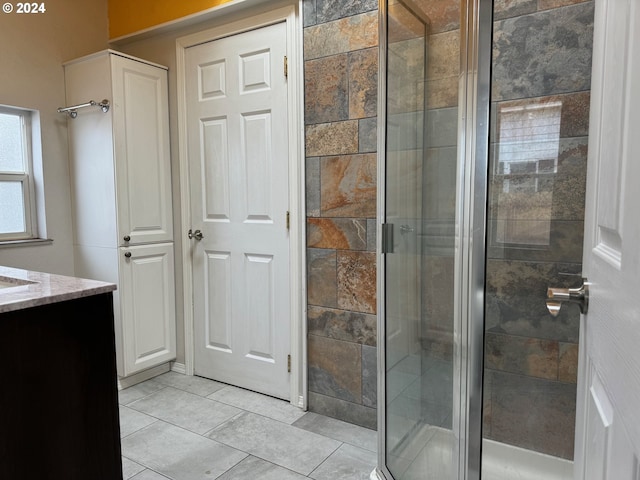 bathroom with vanity, tile patterned flooring, and a shower with door