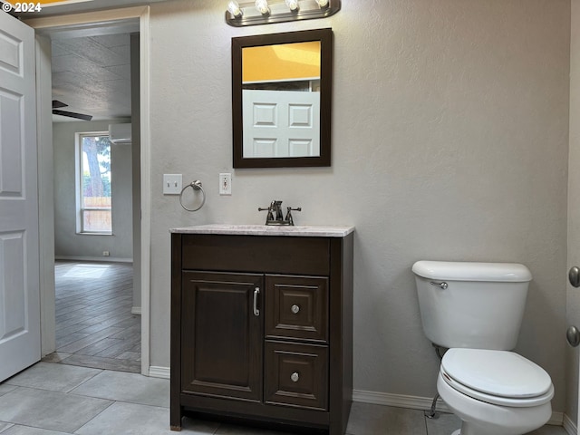 bathroom with vanity, a textured ceiling, wood-type flooring, toilet, and a wall mounted AC