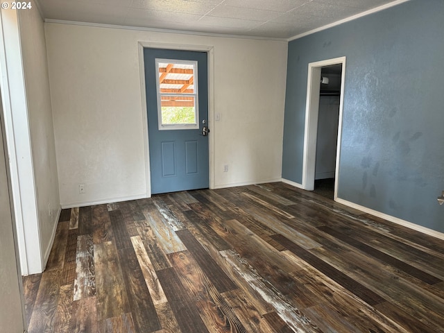 unfurnished room featuring crown molding and dark hardwood / wood-style floors