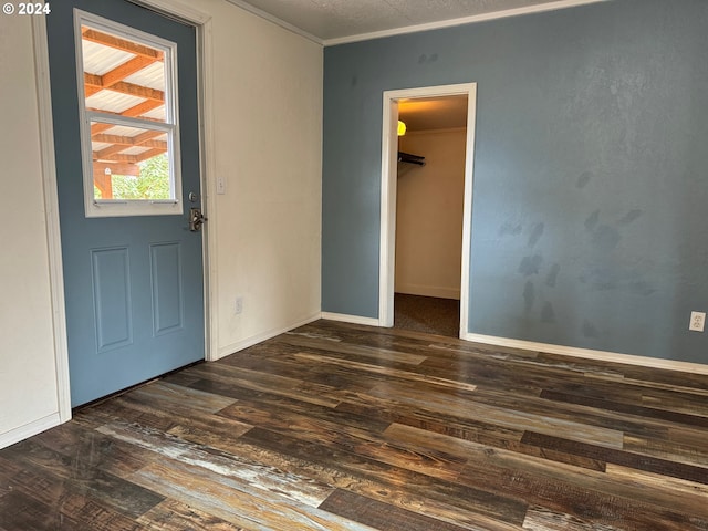 foyer with dark hardwood / wood-style floors and crown molding