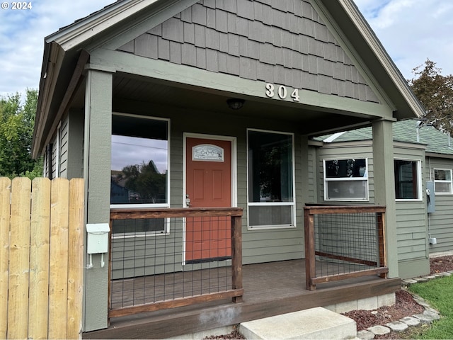 view of exterior entry with covered porch