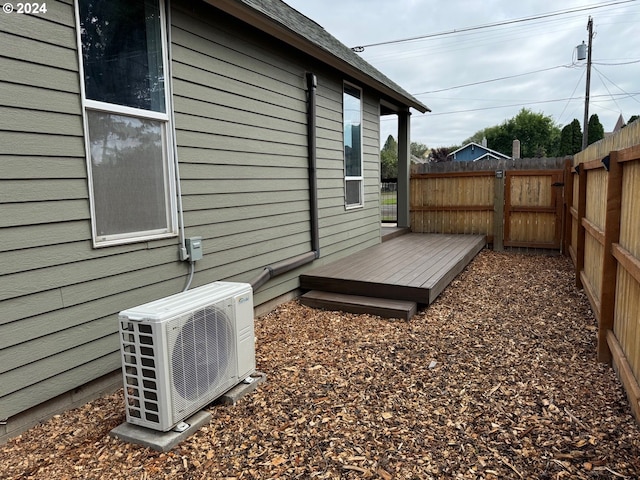 view of yard with ac unit and a wooden deck