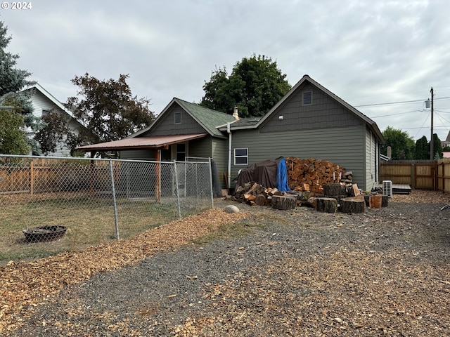 rear view of house with an outdoor fire pit