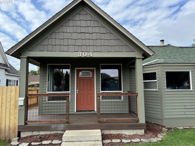 view of exterior entry with covered porch