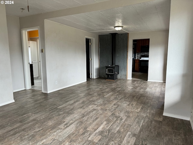 interior space featuring a wood stove and dark wood-type flooring