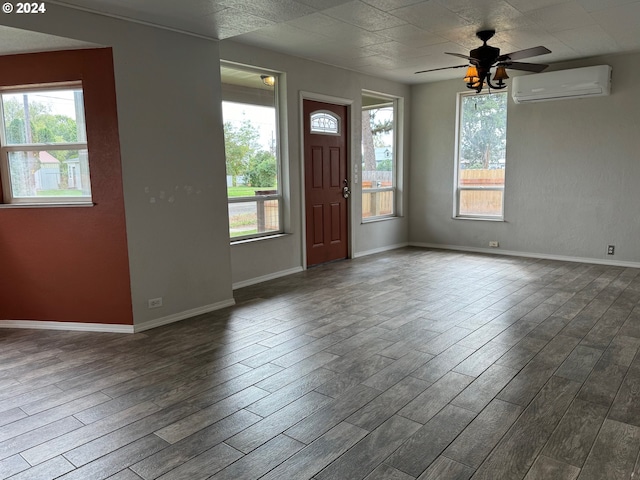 foyer with ceiling fan, dark wood-type flooring, and a wall mounted air conditioner