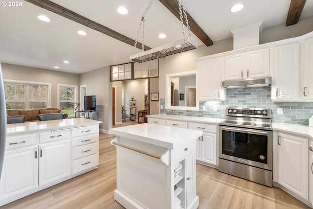 kitchen featuring white cabinetry, beamed ceiling, light hardwood / wood-style floors, stainless steel range with electric stovetop, and a kitchen island