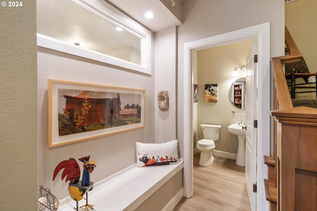 bathroom featuring wood-type flooring and toilet