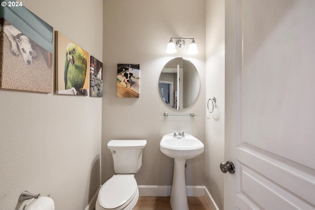 bathroom featuring hardwood / wood-style floors and toilet