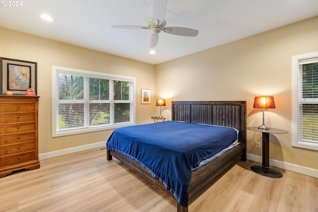 bedroom with ceiling fan and light wood-type flooring