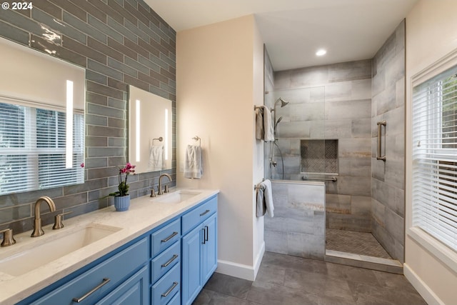 bathroom with vanity and tiled shower