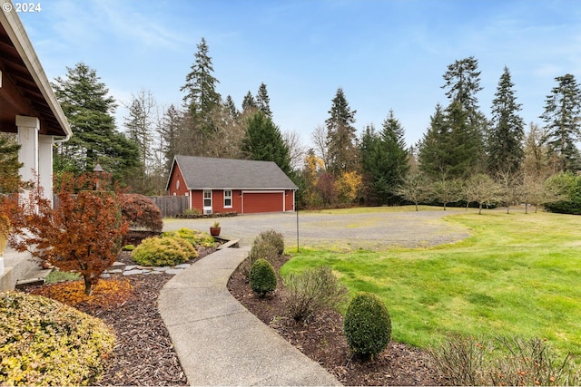 view of yard featuring a garage and an outdoor structure