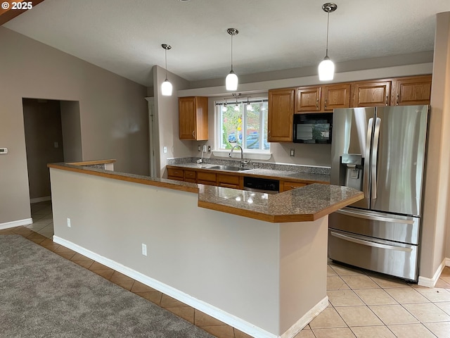 kitchen with stainless steel appliances, sink, light tile patterned floors, hanging light fixtures, and lofted ceiling