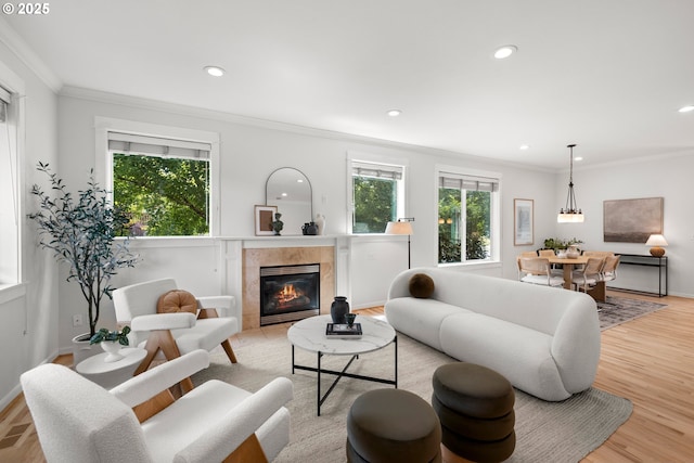 2834 SE Franklin St, Portland, OR 97202 - living room with a tiled fireplace, ornamental molding, recessed lighting, and light wood-style floors