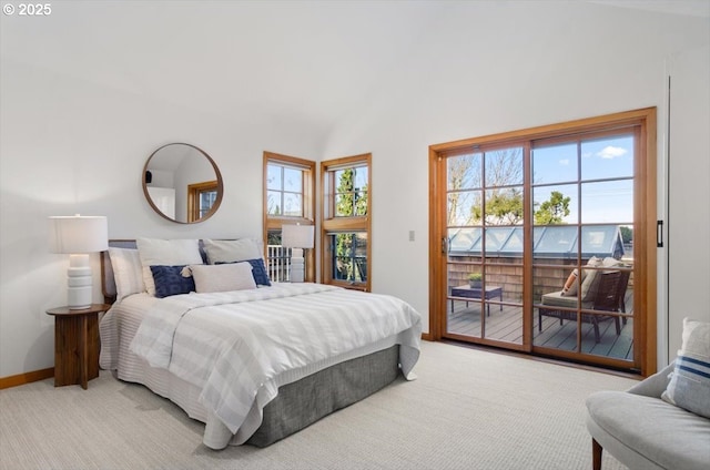 bedroom with access to exterior, carpet floors, and vaulted ceiling