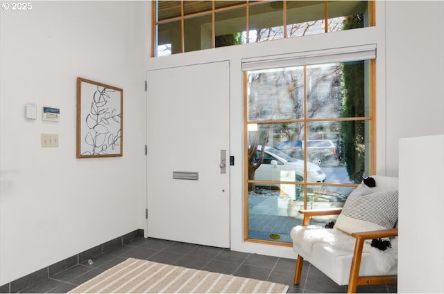 entryway featuring dark tile patterned floors