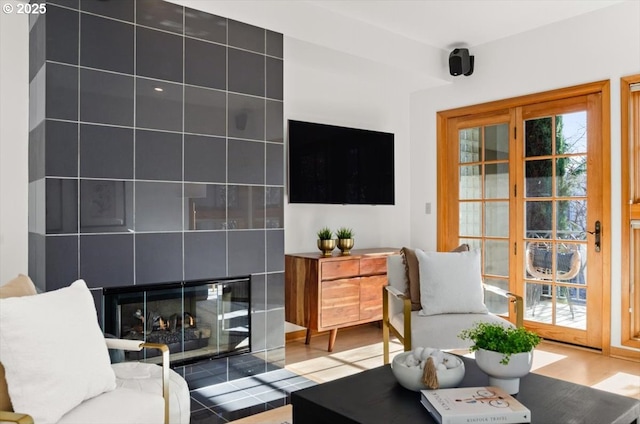 living room with hardwood / wood-style floors and a tile fireplace