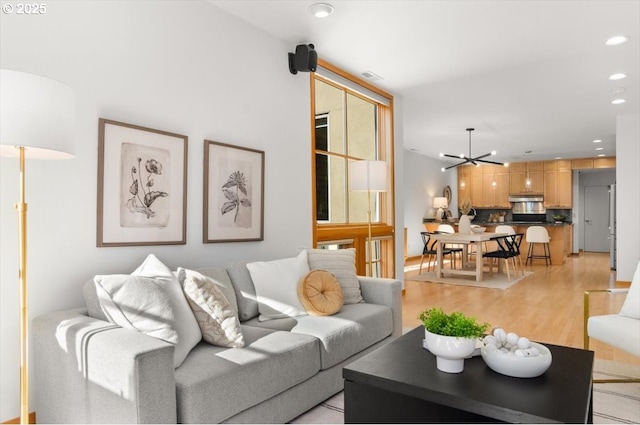 living room featuring a chandelier and light hardwood / wood-style flooring