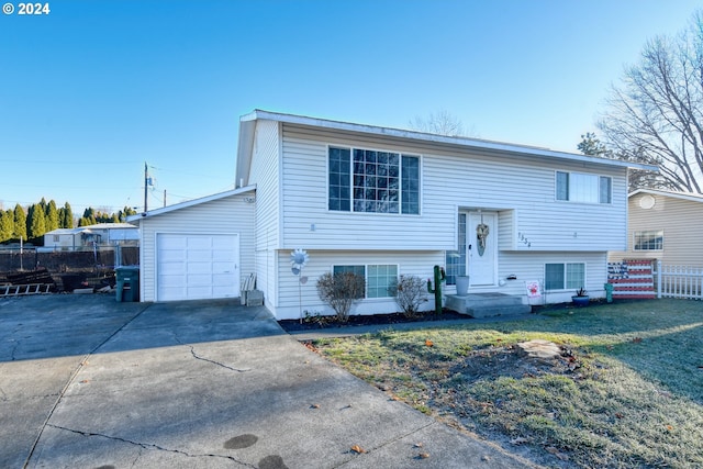 bi-level home with a front yard and a garage