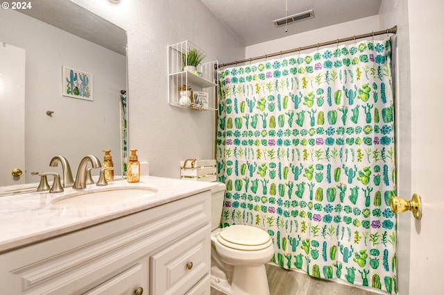 bathroom featuring a shower with curtain, vanity, hardwood / wood-style flooring, and toilet