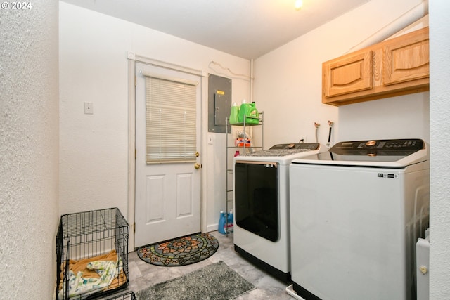 clothes washing area with electric panel, cabinets, and independent washer and dryer