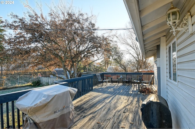 wooden terrace featuring a grill