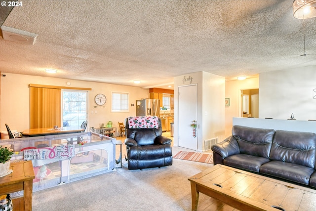 carpeted living room with a textured ceiling