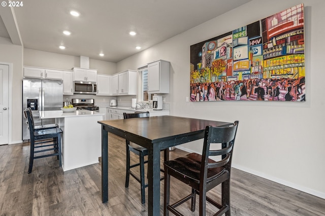 kitchen featuring dark wood-type flooring, stainless steel appliances, sink, and white cabinets