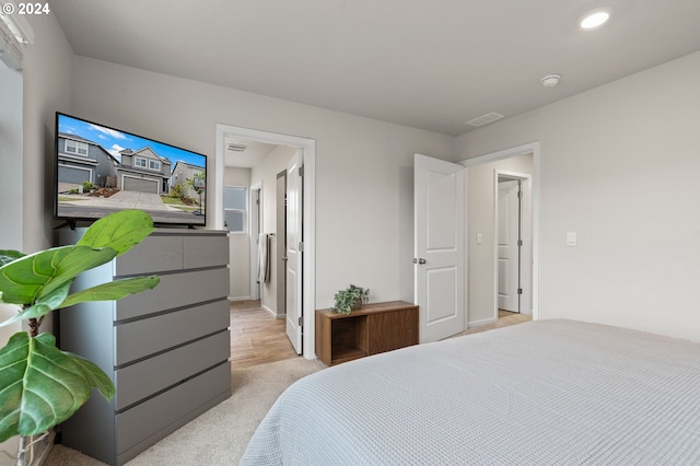 bedroom featuring light colored carpet