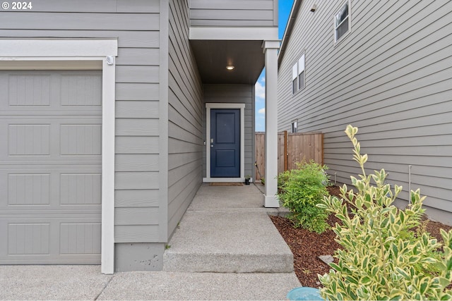 view of exterior entry with a garage