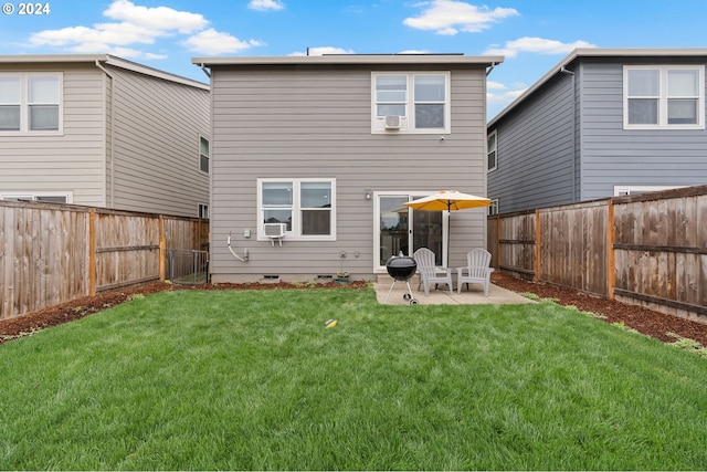 rear view of house with a yard and a patio