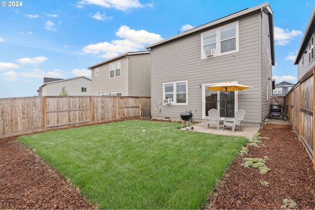 rear view of house with a yard and a patio area