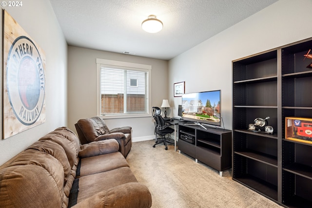 carpeted home office with a textured ceiling