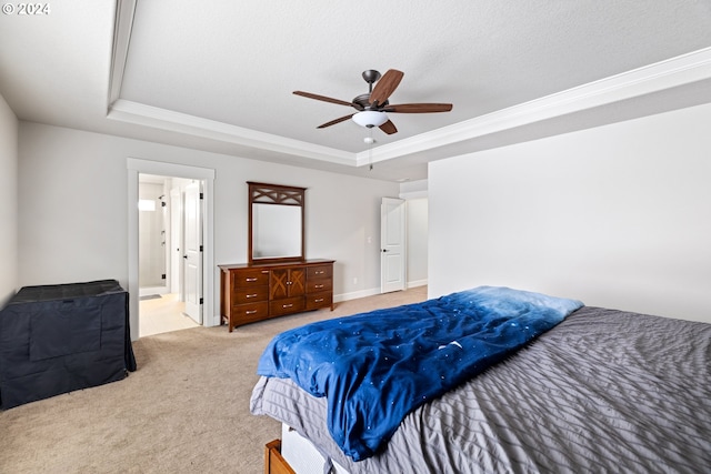 carpeted bedroom featuring a raised ceiling, ceiling fan, ensuite bathroom, and a textured ceiling