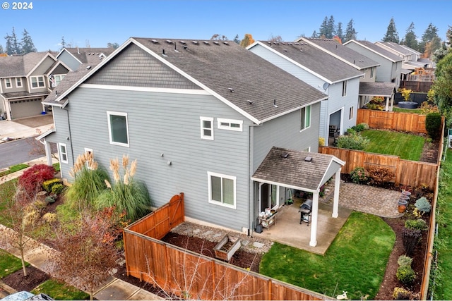 back of property featuring a patio and a lawn