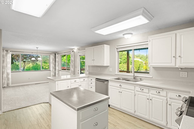 kitchen featuring a wealth of natural light, sink, white cabinets, hanging light fixtures, and kitchen peninsula