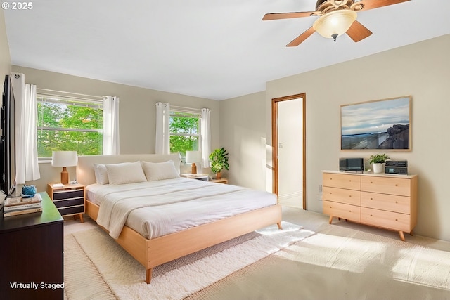 bedroom featuring ceiling fan and light carpet