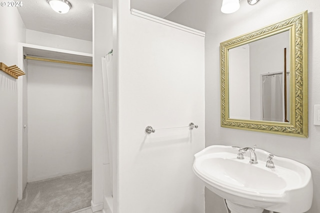 bathroom with sink and a textured ceiling