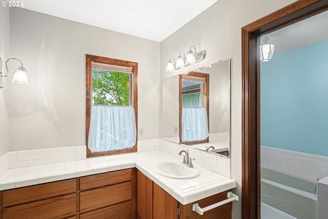 bathroom with vanity and a bathtub