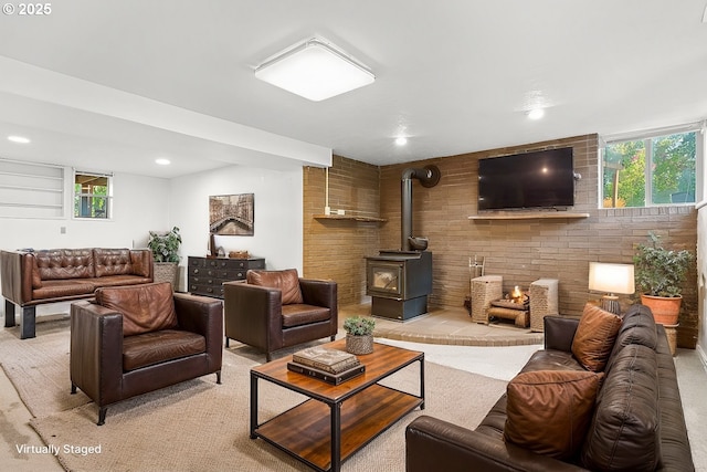 carpeted living room featuring plenty of natural light and a wood stove