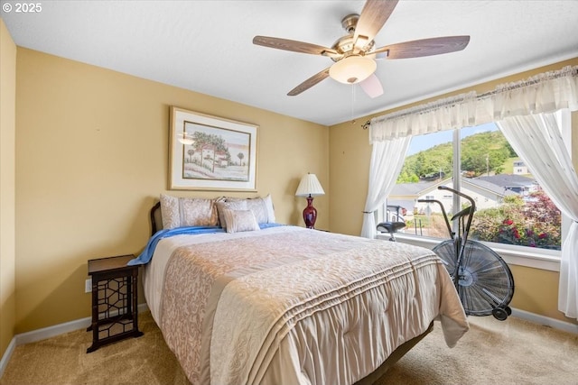 bedroom with carpet flooring, baseboards, and a ceiling fan