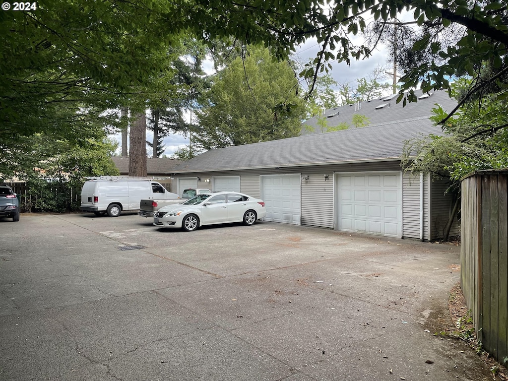 view of parking / parking lot featuring a garage