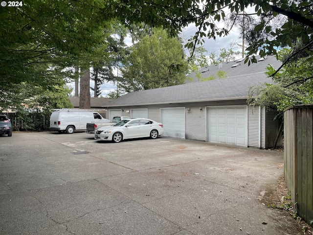 view of parking / parking lot featuring a garage