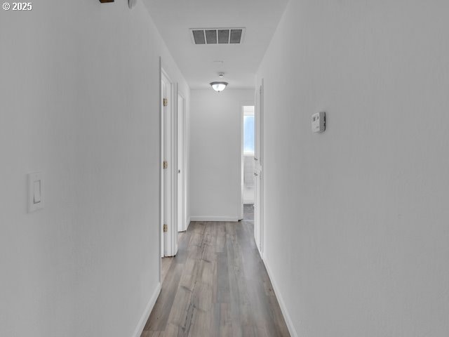 hallway with light hardwood / wood-style flooring