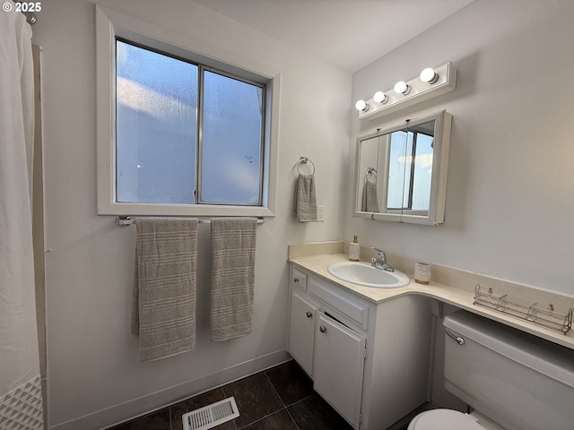 bathroom with vanity, tile patterned floors, and toilet