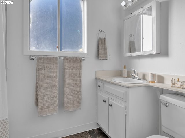 bathroom featuring vanity and toilet