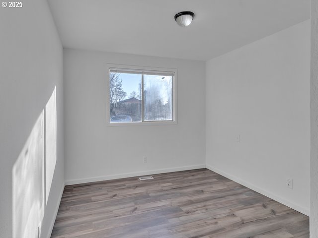 spare room with light wood-type flooring